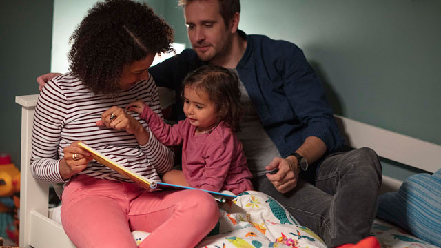 family sat on bed