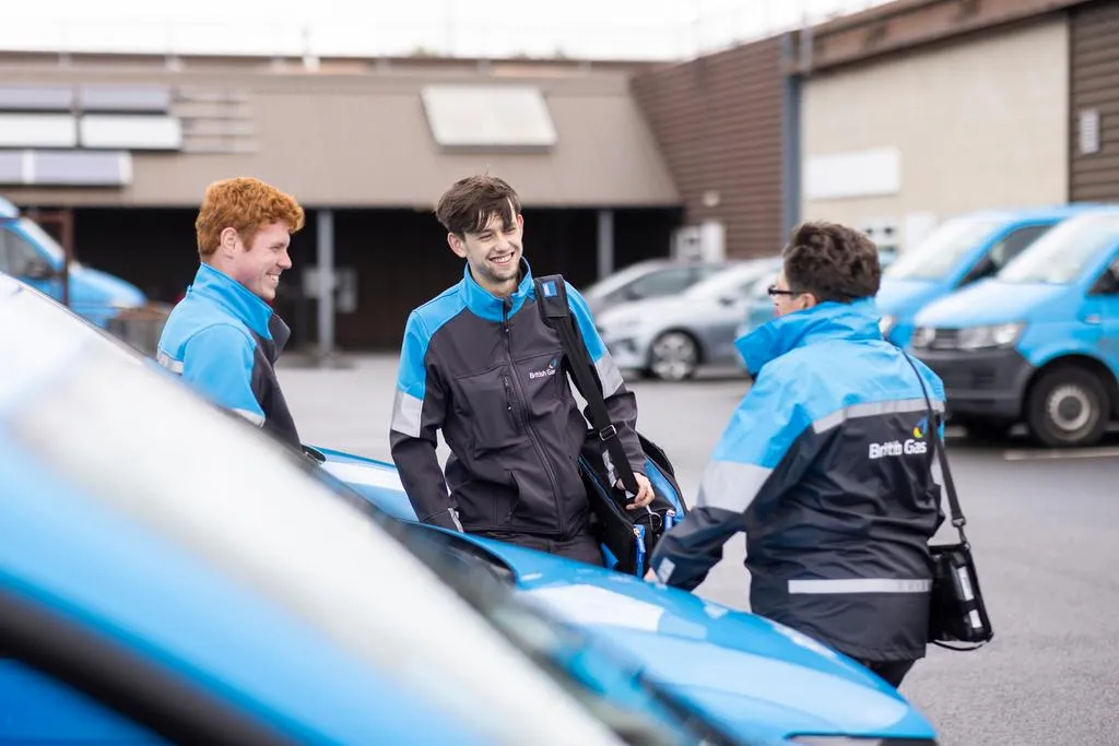 A group of Engineers standing by there vans chatting about work